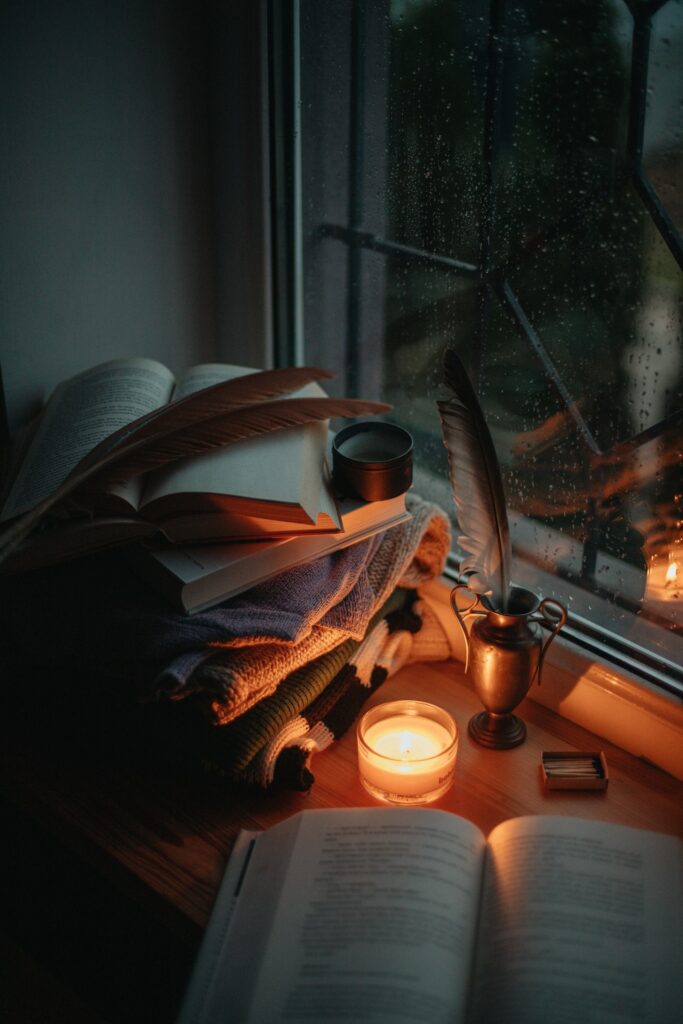 Books and candles on a window sill
