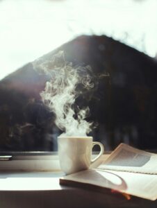 Coffee and a book on a window sill
