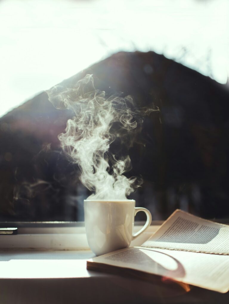 Coffee and a book on a window sill