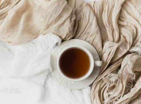 Cup of tea on a soft cream blanket